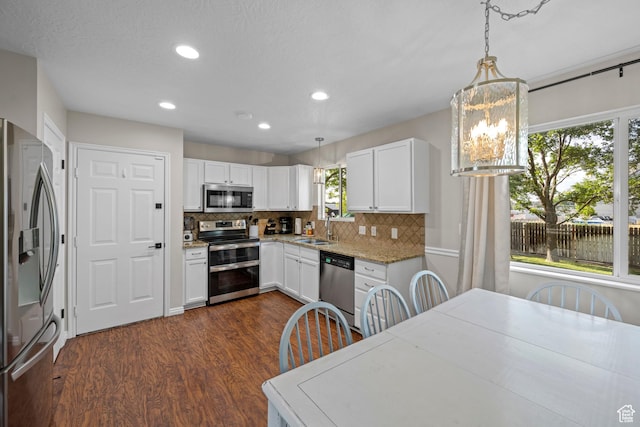 318 W 850 N, Springville, UT 84663 - kitchen with stainless steel appliances, dark wood-style flooring, tasteful backsplash, recessed lighting, and white cabinets