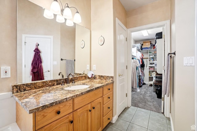 798 E Spruce Tree Ln, Sandy, UT 84094 - bathroom featuring vanity, tile patterned flooring, and a walk in closet