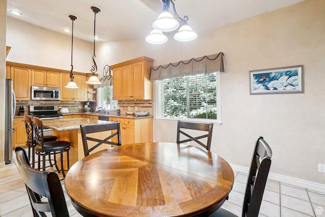 798 E Spruce Tree Ln, Sandy, UT 84094 - dining area featuring light tile patterned floors, vaulted ceiling, and a chandelier