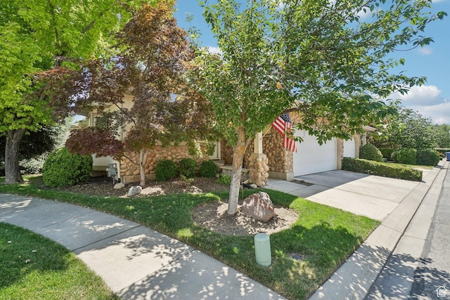798 E Spruce Tree Ln, Sandy, UT 84094 - view of property hidden behind natural elements featuring driveway, stone siding, and an attached garage