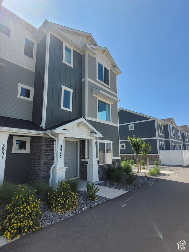 3947 N Aggie Dr Unit 301, Eagle Mountain, UT 84005 - view of front of home featuring board and batten siding and stone siding