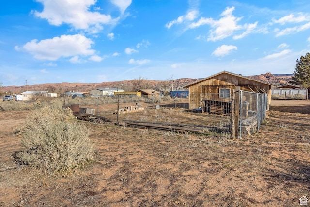 2627 E Cactus Rd, Moab, UT 84532 - view of yard featuring an outbuilding, exterior structure, and a mountain view