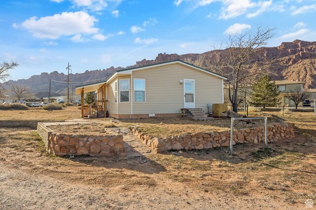 2627 E Cactus Rd, Moab, UT 84532 - view of home's exterior with a mountain view, entry steps, and crawl space