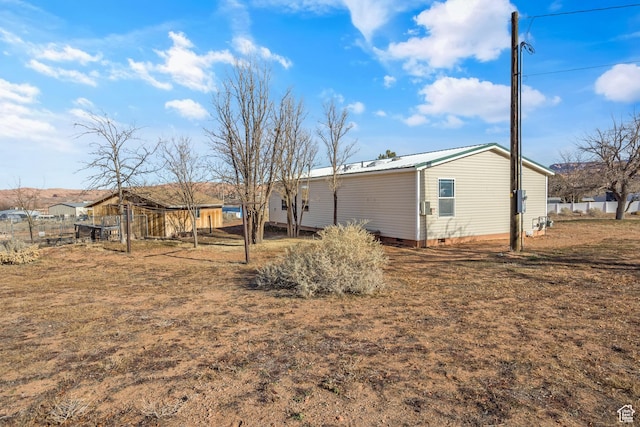 2627 E Cactus Rd, Moab, UT 84532 - back of house featuring crawl space and a metal roof