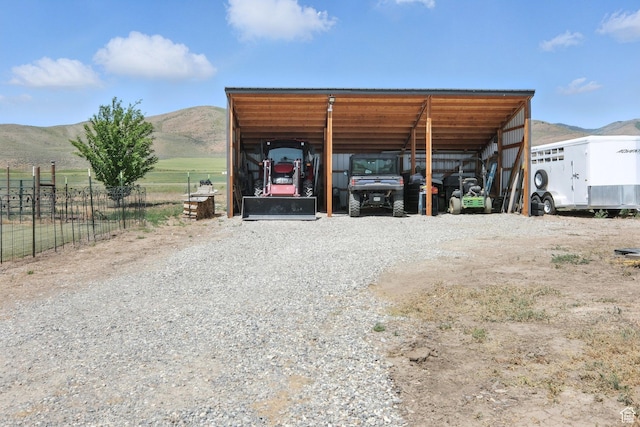 968 S 5400 W, Malad City, ID 83252 - view of outdoor structure with a detached carport, a mountain view, and gravel driveway