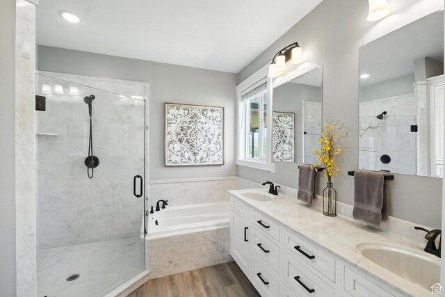 968 S 5400 W, Malad City, ID 83252 - full bathroom featuring a bath, a stall shower, double vanity, and wood finished floors