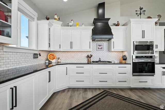 968 S 5400 W, Malad City, ID 83252 - kitchen featuring appliances with stainless steel finishes, custom exhaust hood, dark countertops, and white cabinets