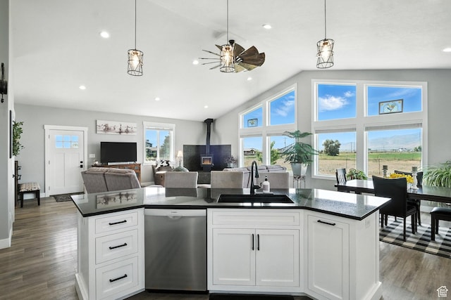 968 S 5400 W, Malad City, ID 83252 - kitchen featuring stainless steel dishwasher, dark countertops, ceiling fan, a wood stove, and open floor plan