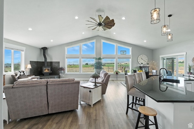 968 S 5400 W, Malad City, ID 83252 - living area with healthy amount of natural light, dark wood-style flooring, a wood stove, vaulted ceiling, and recessed lighting