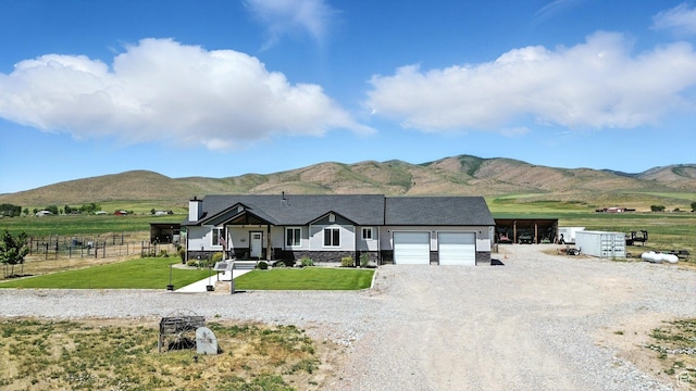 968 S 5400 W, Malad City, ID 83252 - view of front of property featuring a garage, a mountain view, driveway, and a chimney
