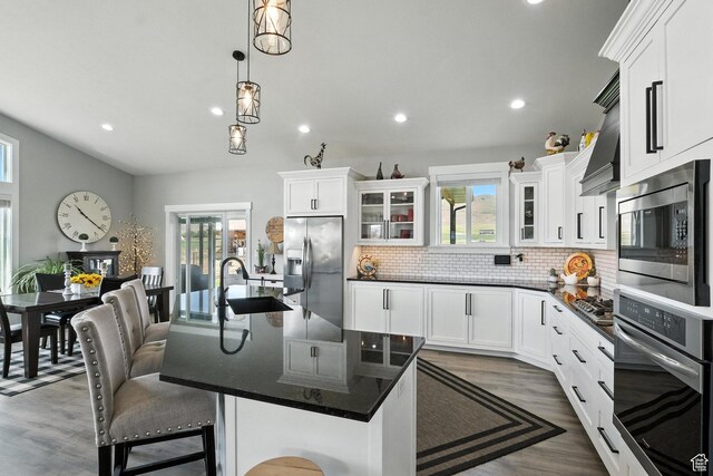 968 S 5400 W, Malad City, ID 83252 - kitchen featuring stainless steel appliances, recessed lighting, tasteful backsplash, glass insert cabinets, and white cabinets