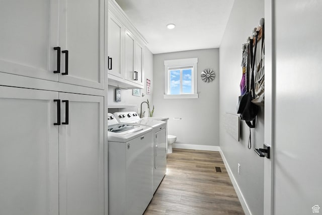 968 S 5400 W, Malad City, ID 83252 - laundry area with washer and dryer, cabinet space, and light wood-style flooring