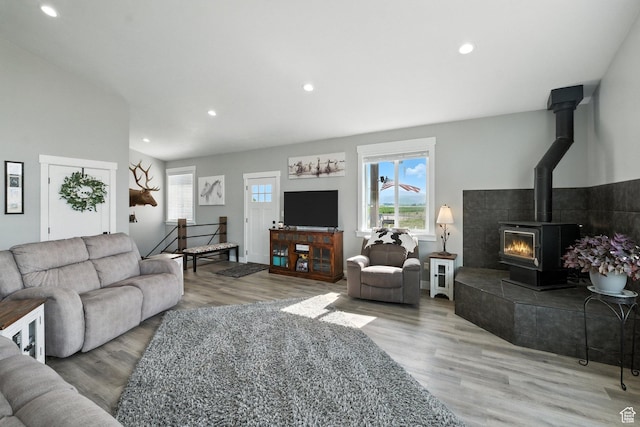 968 S 5400 W, Malad City, ID 83252 - living area with healthy amount of natural light, wood finished floors, recessed lighting, a wood stove, and vaulted ceiling