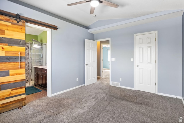 2177 N 125 W, Layton, UT 84041 - unfurnished bedroom with carpet floors, vaulted ceiling, a barn door, ensuite bath, and ceiling fan