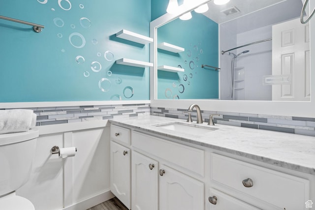 2177 N 125 W, Layton, UT 84041 - bathroom with vanity, tasteful backsplash, a shower, and wood finished floors