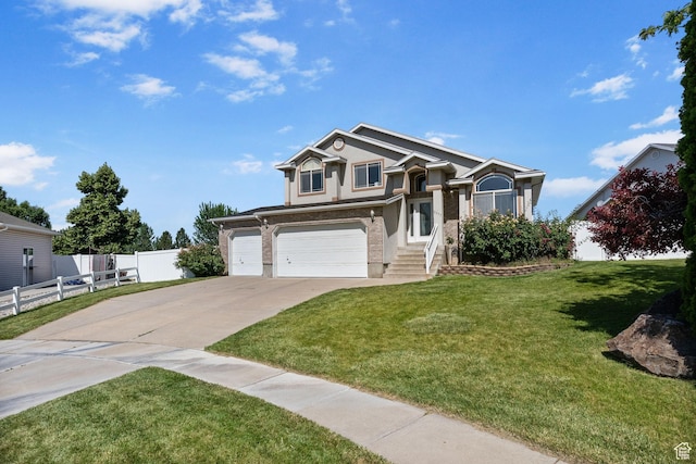 2177 N 125 W, Layton, UT 84041 - view of front of house with driveway, an attached garage, and stucco siding