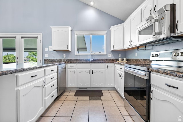 2177 N 125 W, Layton, UT 84041 - kitchen with stainless steel appliances, white cabinets, light tile patterned floors, high vaulted ceiling, and dark stone countertops