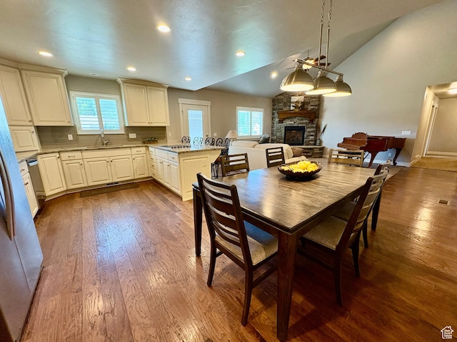 966 E 2810 S, Heber City, UT 84032 - dining space with a fireplace, lofted ceiling, dark wood-style floors, and recessed lighting