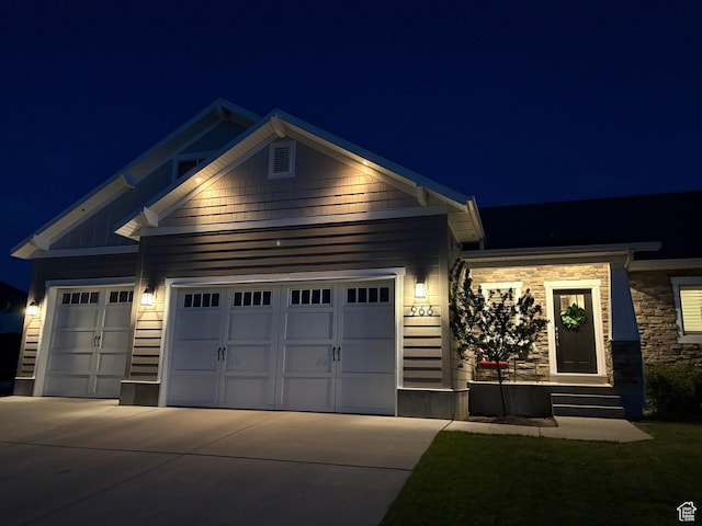 966 E 2810 S, Heber City, UT 84032 - view of front of home with an attached garage, concrete driveway, and stone siding
