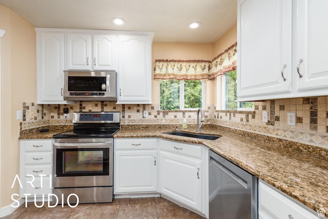 2063 N 775 E, North Ogden, UT 84414 - kitchen featuring stainless steel appliances, stone counters, white cabinetry, decorative backsplash, and recessed lighting