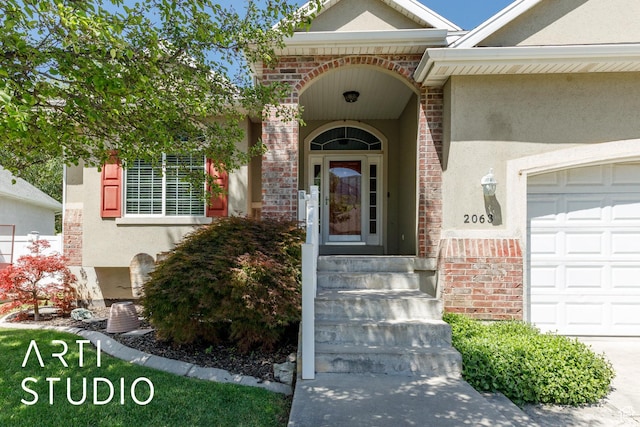 2063 N 775 E, North Ogden, UT 84414 - doorway to property featuring stucco siding and an attached garage