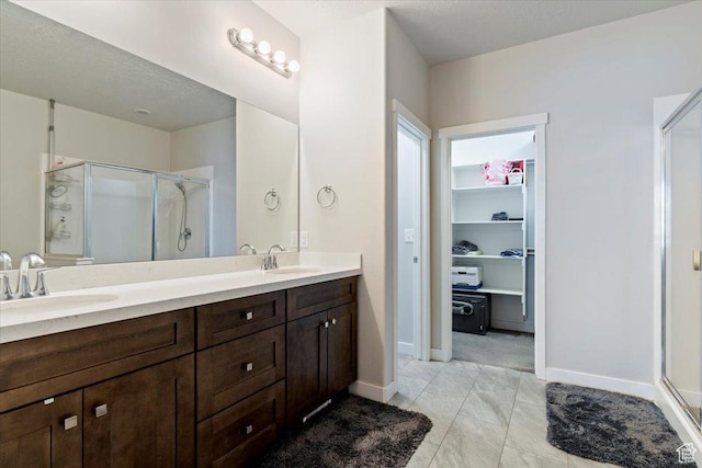 1381 W 425 S, Layton, UT 84041 - bathroom featuring a shower stall, double vanity, a spacious closet, and tile patterned flooring