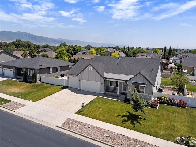 1381 W 425 S, Layton, UT 84041 - view of front of home with board and batten siding, a residential view, concrete driveway, a garage, and a mountain view