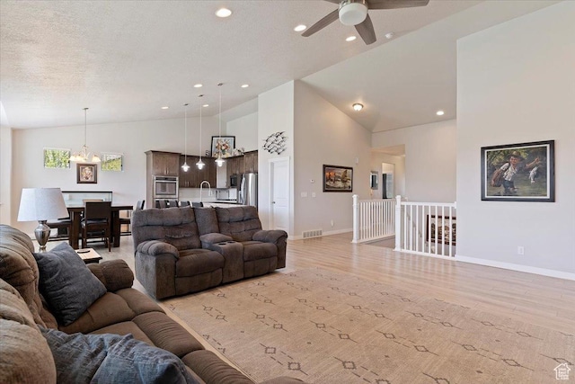 1381 W 425 S, Layton, UT 84041 - living area featuring a chandelier, light wood-style flooring, ceiling fan, recessed lighting, and high vaulted ceiling