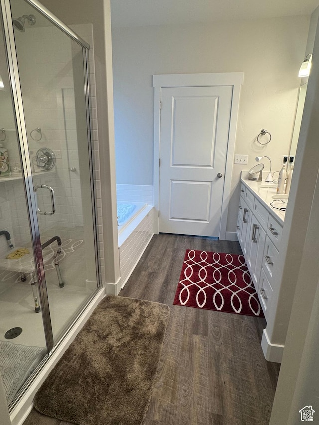 5593 W 5550 S, Hooper, UT 84315 - full bath featuring vanity, a shower stall, a garden tub, and wood finished floors