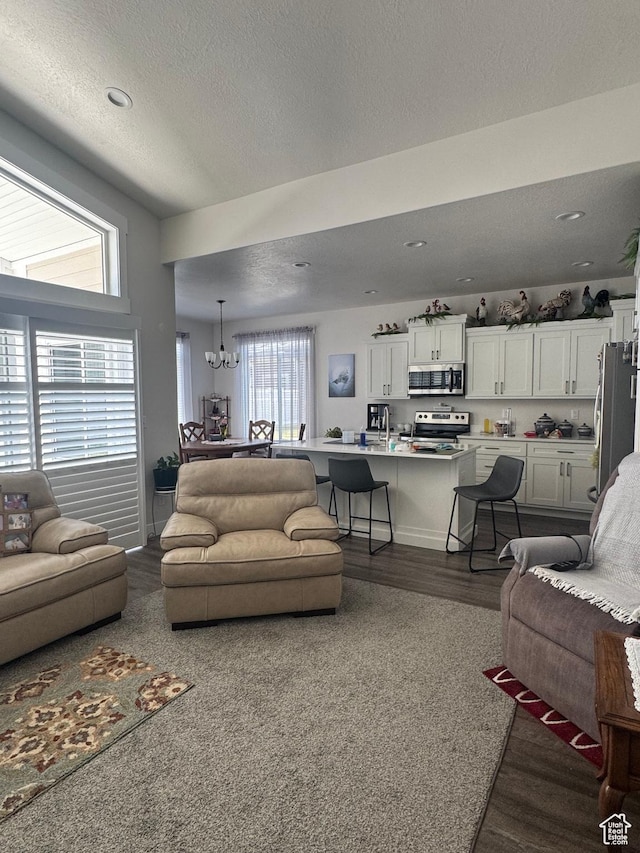 5593 W 5550 S, Hooper, UT 84315 - living room featuring a chandelier, dark wood-style floors, a textured ceiling, and recessed lighting