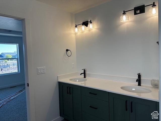 3581 W 725 S Unit 105, West Weber, UT 84401 - bathroom featuring double vanity and baseboards