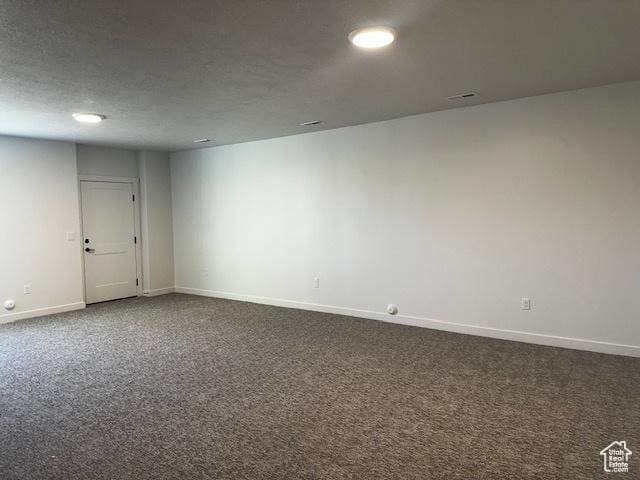 3581 W 725 S Unit 105, West Weber, UT 84401 - spare room featuring baseboards and dark colored carpet