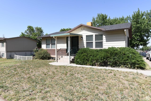 1189 N Quincy Ave, Ogden, UT 84404 - ranch-style home with a chimney and a front yard