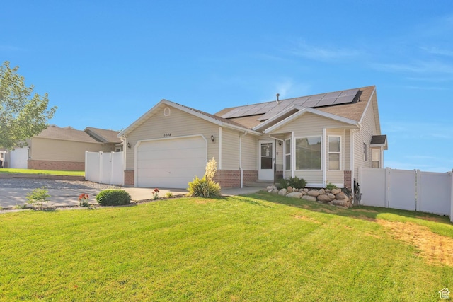 6088 W Graceland Way, West Jordan, UT 84081 - view of front of property with a garage, roof mounted solar panels, a gate, driveway, and brick siding