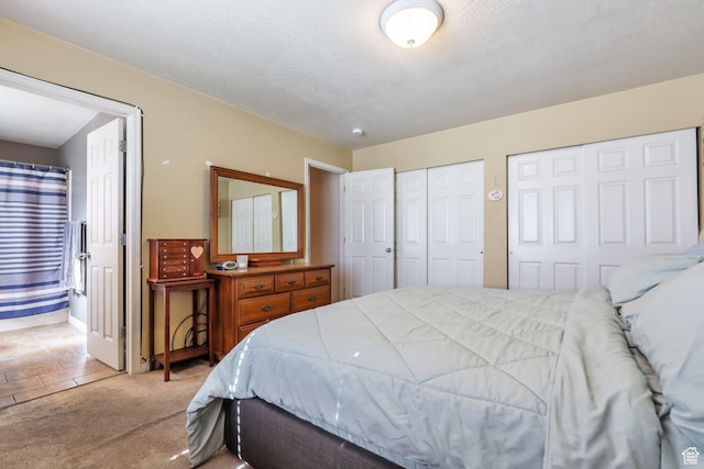 6088 W Graceland Way, West Jordan, UT 84081 - bedroom with multiple closets, light carpet, ensuite bath, and a textured ceiling