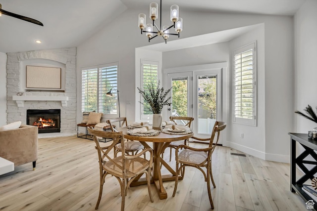 468 W Sunnyrise Ln S, Stansbury Park, UT 84074 - dining room featuring light wood-style floors, a stone fireplace, a chandelier, recessed lighting, and high vaulted ceiling