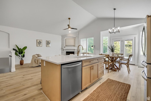 468 W Sunnyrise Ln S, Stansbury Park, UT 84074 - kitchen with appliances with stainless steel finishes, lofted ceiling, a fireplace, light wood-type flooring, and ceiling fan