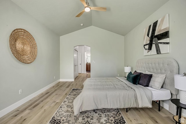 468 W Sunnyrise Ln S, Stansbury Park, UT 84074 - bedroom featuring arched walkways, light wood-style flooring, lofted ceiling, and a ceiling fan