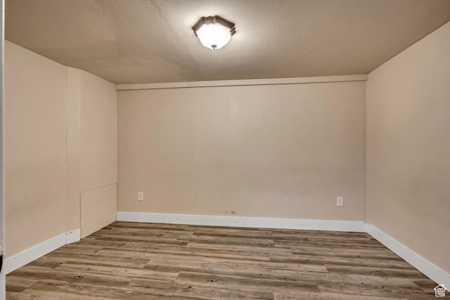 468 W Sunnyrise Ln S, Stansbury Park, UT 84074 - empty room featuring wood finished floors and a textured ceiling