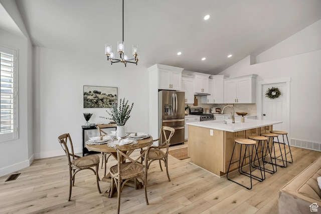 468 W Sunnyrise Ln S, Stansbury Park, UT 84074 - kitchen with stainless steel appliances, light countertops, recessed lighting, light wood finished floors, and a chandelier