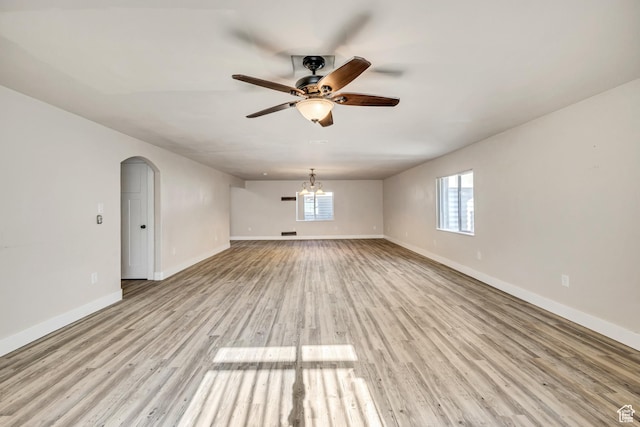 468 W Sunnyrise Ln S, Stansbury Park, UT 84074 - empty room with ceiling fan, light wood-style flooring, and arched walkways