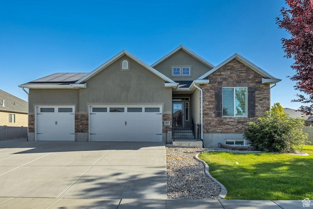 468 W Sunnyrise Ln S, Stansbury Park, UT 84074 - view of front of house featuring stucco siding, stone siding, driveway, a front lawn, and an attached garage