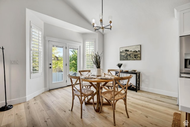 468 W Sunnyrise Ln S, Stansbury Park, UT 84074 - dining area with a chandelier, vaulted ceiling, and light wood-style floors