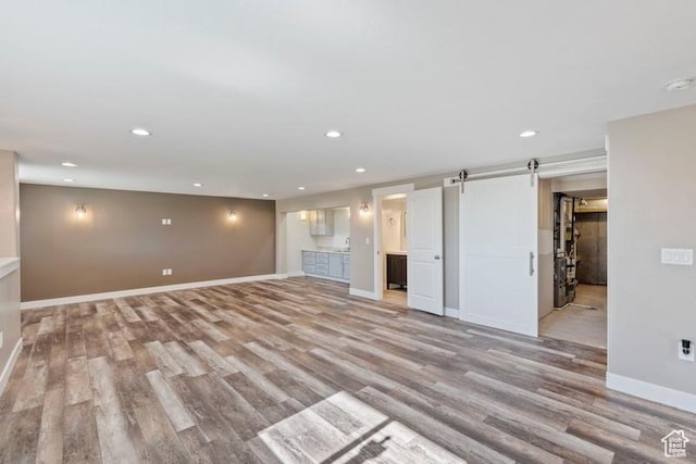 1717 N 4325 W, West Point, UT 84015 - unfurnished living room featuring light wood-style floors, recessed lighting, and a barn door