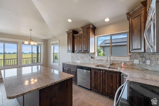 1717 N 4325 W, West Point, UT 84015 - kitchen with appliances with stainless steel finishes, plenty of natural light, decorative backsplash, vaulted ceiling, and recessed lighting