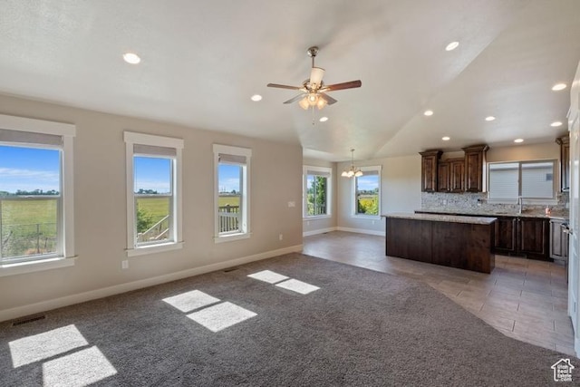 1717 N 4325 W, West Point, UT 84015 - kitchen featuring a center island, open floor plan, recessed lighting, dark brown cabinetry, and tasteful backsplash