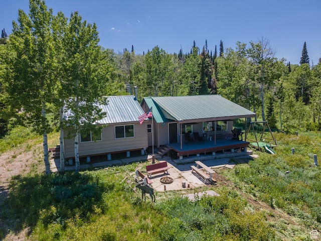 0, Paradise, UT 84328 - rear view of house with an outdoor fire pit, a deck, a forest view, and a metal roof