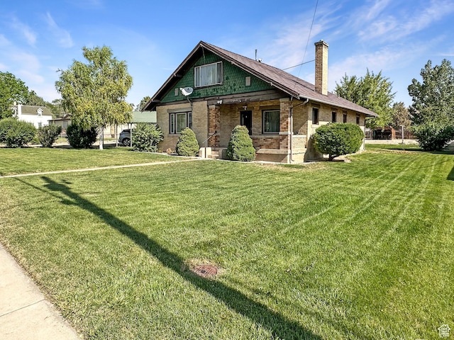 140 W 100 N, Castle Dale, UT 84513 - view of front of house featuring a front lawn, a chimney, and brick siding