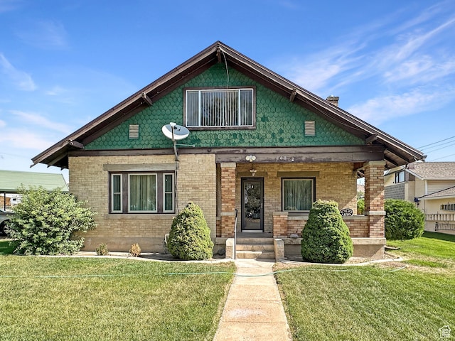 140 W 100 N, Castle Dale, UT 84513 - view of front of home with a front lawn, covered porch, and brick siding