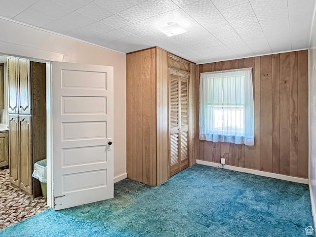 140 W 100 N, Castle Dale, UT 84513 - unfurnished bedroom featuring carpet, wooden walls, and a closet